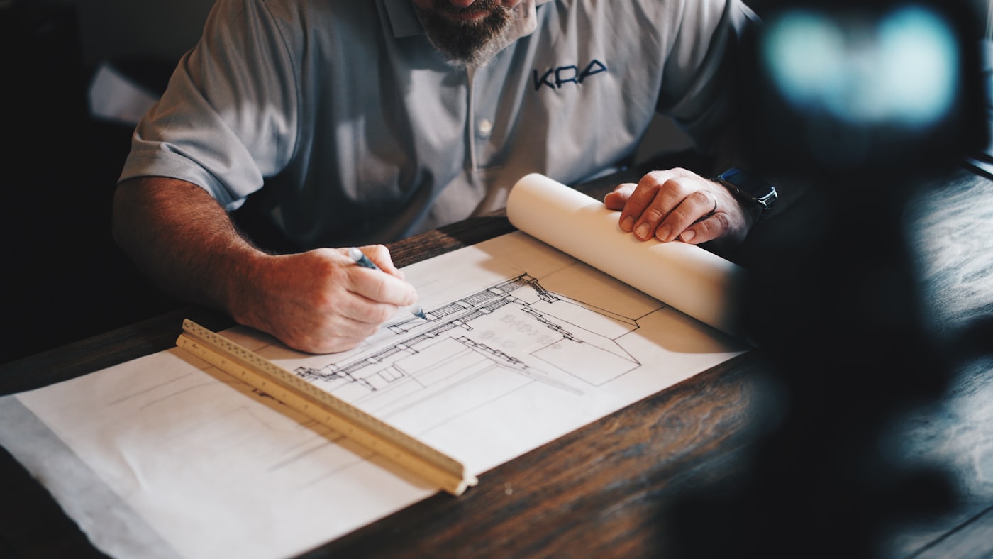 Hand-drawn construction detail being drafted with a ruler