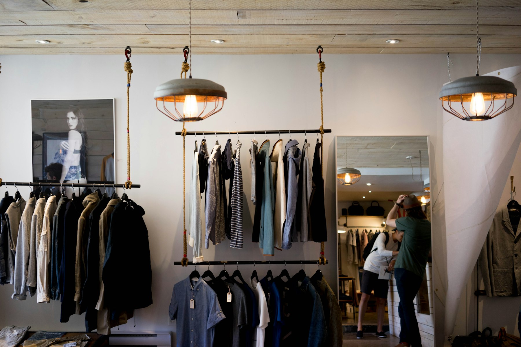 Interior of the Marlowe fitting room with racks of clothing and a mirror