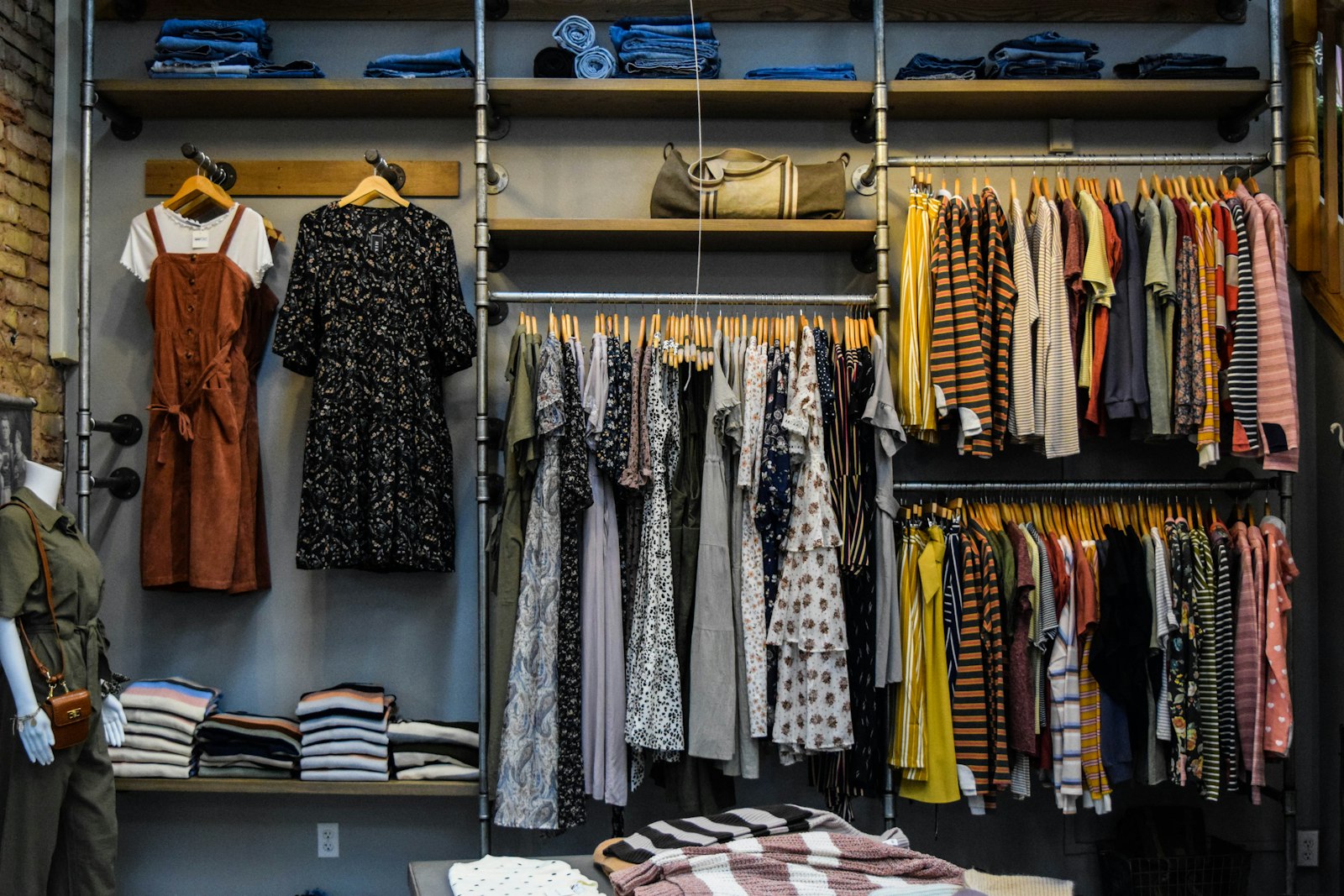 Boutique shelving with folded clothing and hanging garments